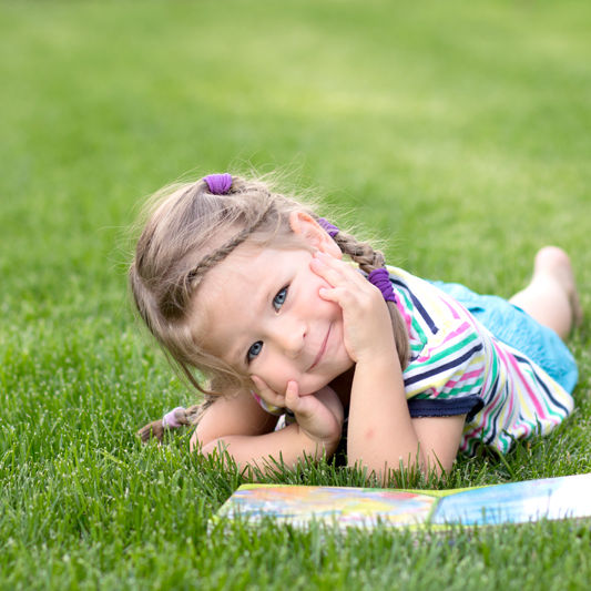 Kid Reading Grass